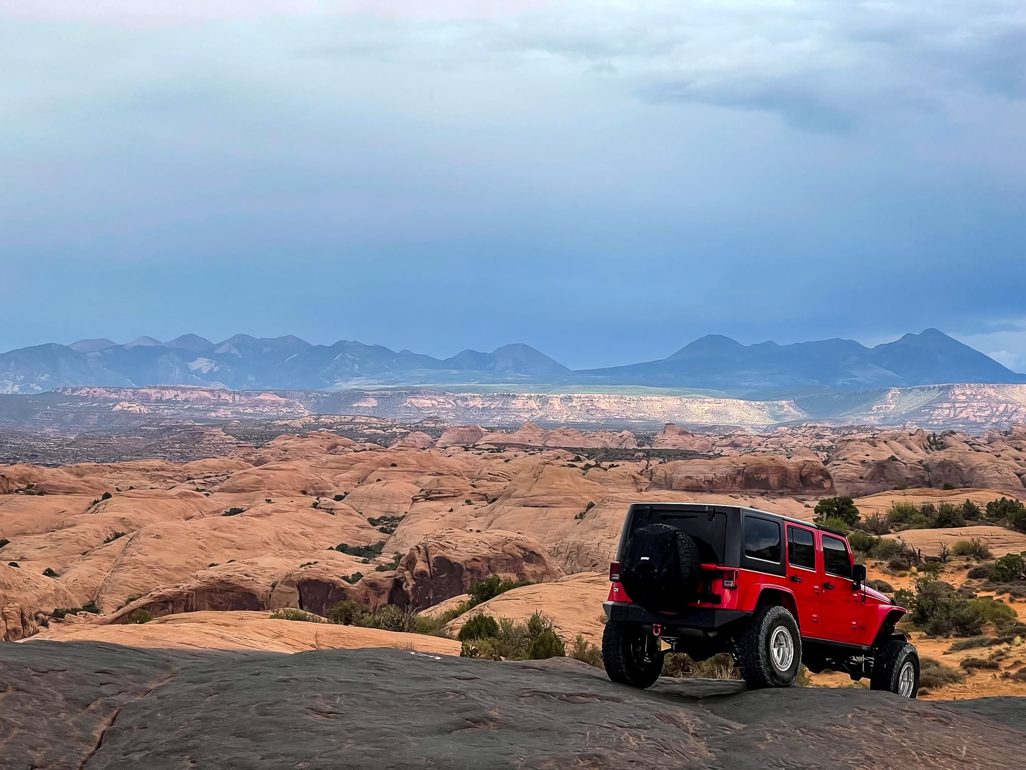 Big Red overlooking the red rock landscape from Hell's Revenge in Moab